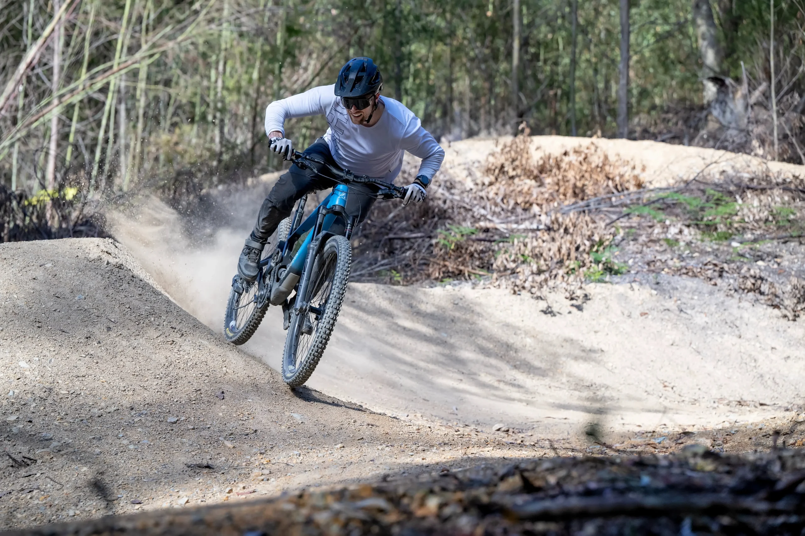 Hamish Armstrong riding a mountain bike on a dirt trail, showcasing his adventurous personality as the author of Success by 1000 Cuts.